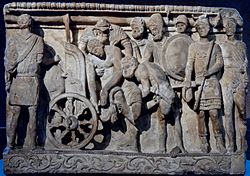 Le corps de Patrocle est soulevé par Menelas et Merion tandis qu'Ulysse et d'autres regardent - relief étrusque- IIe siècle av.JC